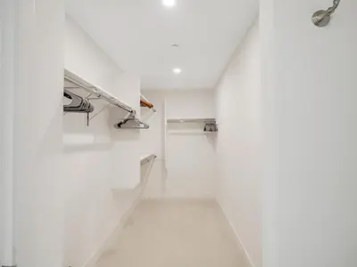 a hallway with white walls and a stairway at Coastal retreat near the beach w Panoramic Ocean Views, Rooftop Deck, & Firepit in San Diego