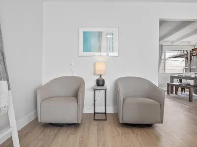 two chairs and a lamp in a room at Oceanfront Paradise - Spa, Pet-Friendly, Fast Wifi, Parking & Dream Views in San Diego