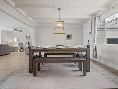 a dining room with a wooden table and a bench at Oceanfront Paradise - Spa, Pet-Friendly, Fast Wifi, Parking & Dream Views in San Diego
