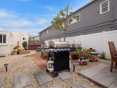 a backyard with a grill in a yard at Oceanfront Paradise - Spa, Pet-Friendly, Fast Wifi, Parking & Dream Views in San Diego