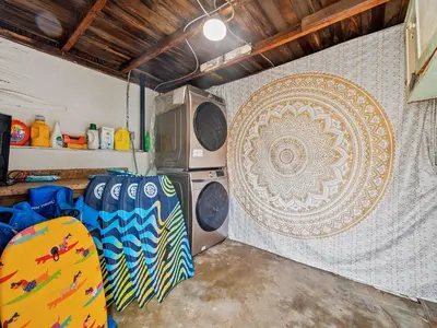 a garage with a surfboard and a wall with a mandala at Oceanfront Paradise - Spa, Pet-Friendly, Fast Wifi, Parking & Dream Views in San Diego