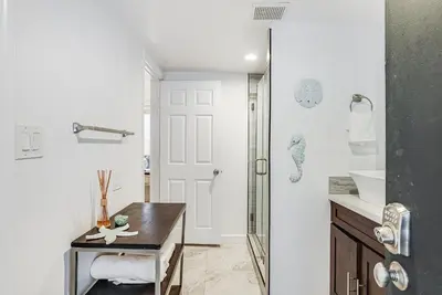 a bathroom with a desk and a sink at Massive Beach Home w Stunning Rooftop, Parking, Spa, AC & Bay Views! in San Diego