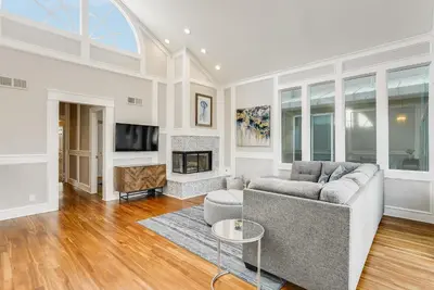 a living room with a couch and a fireplace at Massive Beach Home w Stunning Rooftop, Parking, Spa, AC & Bay Views! in San Diego
