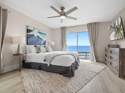 a bedroom with a bed with a view of the ocean at Stunning Oceanfront Villa - Massive Patio, Hot Tub, Parking, Pet Friendly & Views! in San Diego