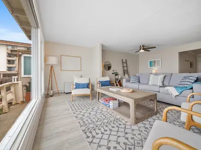 a living room with a couch and a table at Stunning Oceanfront Villa - Massive Patio, Hot Tub, Parking, Pet Friendly & Views! in San Diego