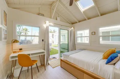 a bedroom with a bed and a desk and a window at Sunset Cliffs Oceanfront Casita w Fast Wifi, Large Outdoor Space & Ocean Breeze! in San Diego