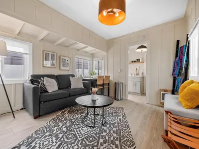 a living room with a couch and a table at Sunset Cliffs Oceanfront Casita w Fast Wifi, Large Outdoor Space & Ocean Breeze! in San Diego