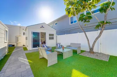 a patio with a table and chairs and a tree at Sunset Cliffs Oceanfront Casita w Fast Wifi, Large Outdoor Space & Ocean Breeze! in San Diego
