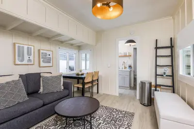 a living room with a couch and a table at Sunset Cliffs Oceanfront Casita w Fast Wifi, Large Outdoor Space & Ocean Breeze! in San Diego
