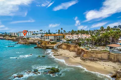 a view of a beach with buildings and the ocean at Sunset Cliffs Oceanfront Casita w Fast Wifi, Large Outdoor Space & Ocean Breeze! in San Diego