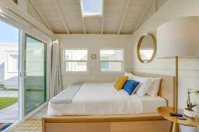 a bedroom with a bed and a large window at Sunset Cliffs Oceanfront Casita w Fast Wifi, Large Outdoor Space & Ocean Breeze! in San Diego