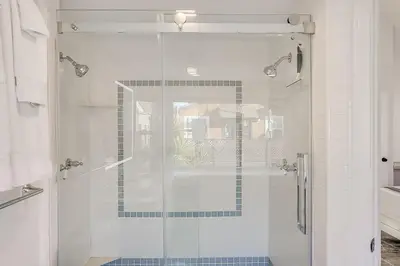 a shower with a glass door in a bathroom at Beautiful Beach Home - Ocean View, AC & Patio in San Diego