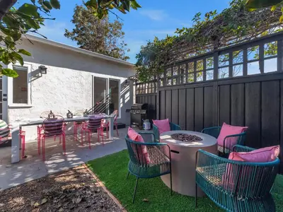 a patio with chairs and a table and a grill at Classic Beach Bungalow - Parking, Private Patio & Pet Friendly! in San Diego