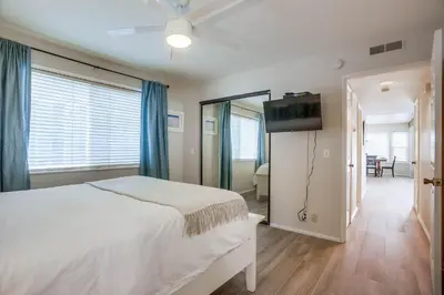 a bedroom with a bed and a flat screen tv at Ormond Beach Oasis - Large Private Patio, WasherDryer, Pet Friendly & Steps2Sand! in San Diego