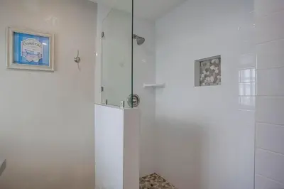 a shower with a glass door in a bathroom at Ormond Beach Oasis - Large Private Patio, WasherDryer, Pet Friendly & Steps2Sand! in San Diego