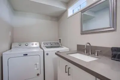 a kitchen with a dishwasher and a sink and a stove at Ormond Beach Oasis - Large Private Patio, WasherDryer, Pet Friendly & Steps2Sand! in San Diego