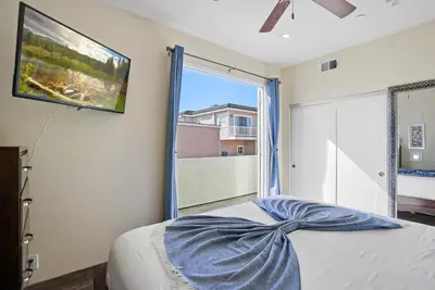 a bedroom with a bed and a large window at Ocean View Paradise w Private Patio & Spa in San Diego
