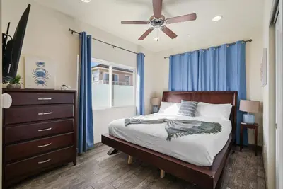 a bedroom with a bed and a ceiling fan at Ocean View Paradise w Private Patio & Spa in San Diego