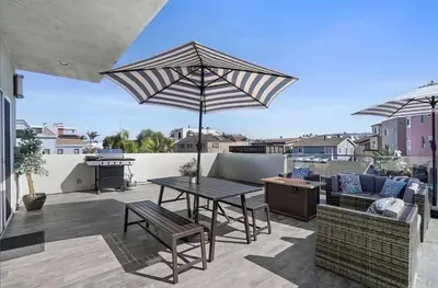 a patio with a table and chairs and an umbrella at Ocean View Paradise w Private Patio & Spa in San Diego