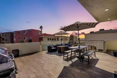 a patio with a table and chairs and an umbrella at Ocean View Paradise w Private Patio & Spa in San Diego