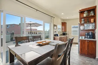 a kitchen and dining room with a table and chairs at Ocean View Paradise w Private Patio & Spa in San Diego