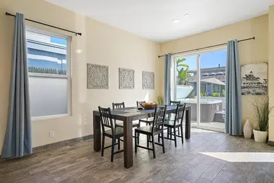 a dining room with a table and chairs and a window at Mission Paradise - Spa, Pet Friendly, Steps2Sand in San Diego