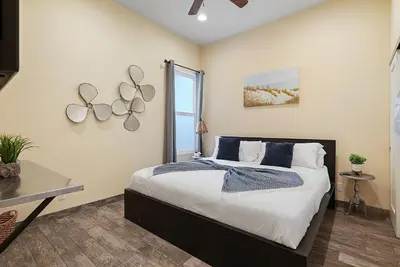a bedroom with a large bed and a window at Mission Paradise - Spa, Pet Friendly, Steps2Sand in San Diego