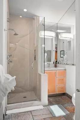 a bathroom with a shower and a sink at Stunning Oceanfront Boardwalk Condo - Spa, Steps2Beach, Parking & Fast Wifi! in San Diego