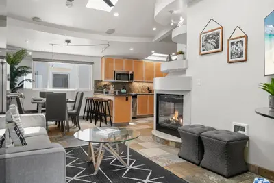a living room with a couch and a fireplace at Stunning Oceanfront Boardwalk Condo - Spa, Steps2Beach, Parking & Fast Wifi! in San Diego