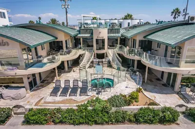 an aerial view of a resort with a swimming pool at Stunning Oceanfront Boardwalk Condo - Spa, Steps2Beach, Parking & Fast Wifi! in San Diego