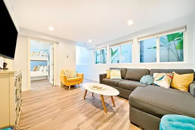 a living room with a couch and a table at Stunning South Mission Home with Private Rooftop & Ocean Views! in San Diego