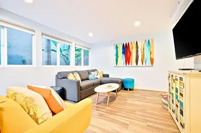 a living room with a couch and a table at Stunning South Mission Home with Private Rooftop & Ocean Views! in San Diego