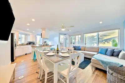 a kitchen and living room with a table and a couch at Stunning South Mission Home with Private Rooftop & Ocean Views! in San Diego