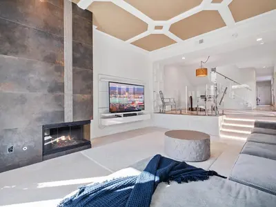 a living room with a fireplace and a tv at Windansea Beach Luxury - Spa, AC, Walk2Beach, Garage & fast WiFi in San Diego