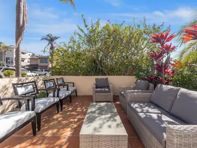 a row of couches and chairs on a patio at Windansea Beach Luxury - Spa, AC, Walk2Beach, Garage & fast WiFi in San Diego