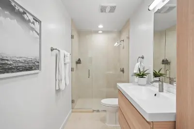 a bathroom with a sink and a toilet and a shower at Birdrock Paradise w Private Pool& Spa, AC, fast WiFi & Yard! in San Diego