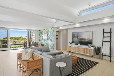 a living room with a couch and a tv at Birdrock Paradise w Private Pool& Spa, AC, fast WiFi & Yard! in San Diego