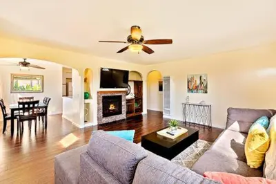 a living room with a couch and a ceiling fan at Pacific Oasis - Large Patio, Parking & Walk to Beach in San Diego