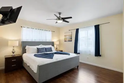 a bedroom with a bed and a ceiling fan at Pacific Oasis - Large Patio, Parking & Walk to Beach in San Diego