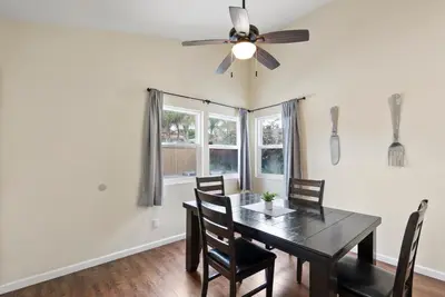 a dining room with a table and chairs and a ceiling fan at Pacific Paradise - Large Patio, Hot Tub, Short Walk to Beach, & Parking in San Diego