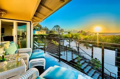 a balcony with couches and a view of the ocean at Endless Vistas On The Cove Perfection - Spa, Pet-Friendly, Stunning Views, Large Parking & AC in San Diego