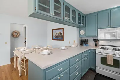 a kitchen with blue cabinets and a counter top at Stunning Beach Home - Steps to the Bay,Beach, &Boardwalk w Grill & Patios in San Diego