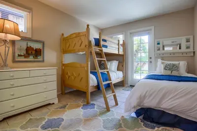 a bedroom with two bunk beds and a dresser at Stunning Beach Home - Steps to the Bay,Beach, &Boardwalk w Grill & Patios in San Diego