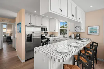a kitchen with white cabinets and a large counter top at Bay View Paradise - Rooftop Deck, Off-Street Parking, King Suite, WasherDryer & Bay Views! in San Diego
