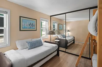 a bedroom with a bed and a ladder and a bed and window at Bay View Paradise - Rooftop Deck, Off-Street Parking, King Suite, WasherDryer & Bay Views! in San Diego