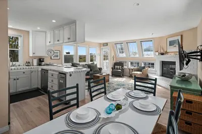a kitchen and living room with a table and chairs at Bay View Paradise - Rooftop Deck, Off-Street Parking, King Suite, WasherDryer & Bay Views! in San Diego
