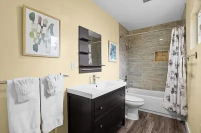 a bathroom with a sink and a toilet and a shower at Dog Friendly Home Near the Beach with Grill, Fire Pit, Enclosed Backyard in San Diego