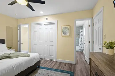 a bedroom with a bed and a ceiling fan at Dog Friendly Home Near the Beach with Grill, Fire Pit, Enclosed Backyard in San Diego