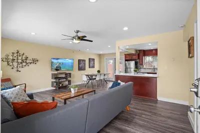 a living room with a couch and a table at Dog Friendly Home Near the Beach with Grill, Fire Pit, Enclosed Backyard in San Diego