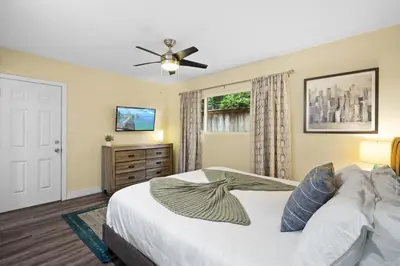 a bedroom with a bed and a ceiling fan at Dog Friendly Home Near the Beach with Grill, Fire Pit, Enclosed Backyard in San Diego